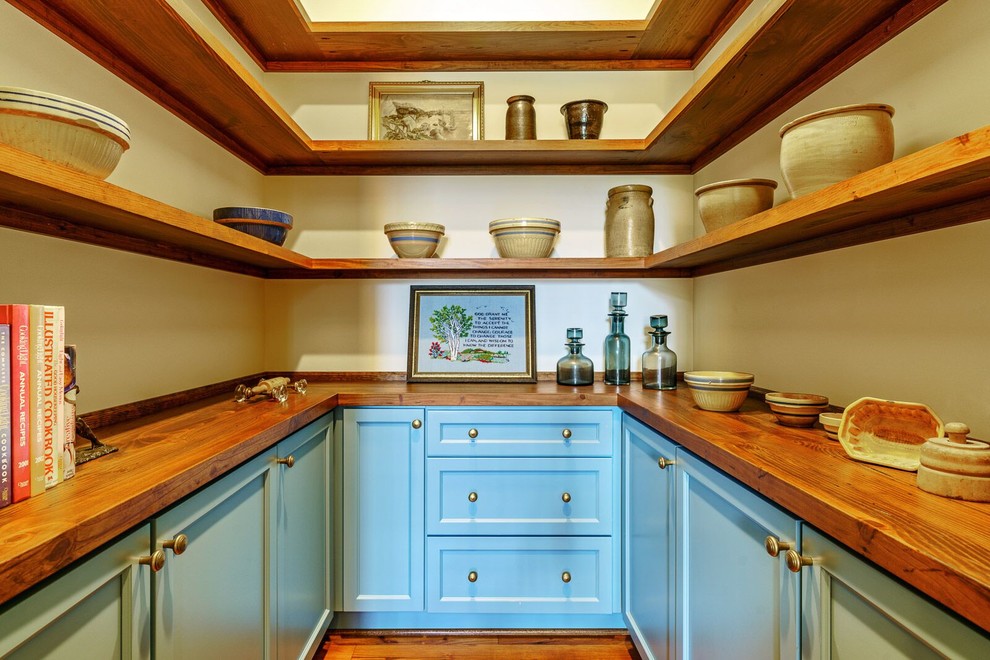 Farmhouse u-shaped dark wood floor and brown floor kitchen pantry photo in Other with shaker cabinets, blue cabinets, wood countertops and brown countertops
