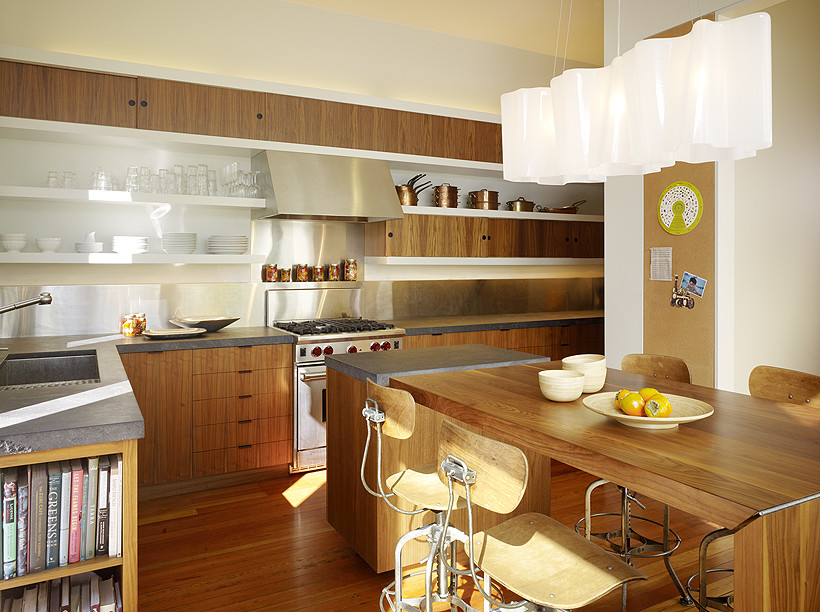 Eat-in kitchen - modern l-shaped light wood floor eat-in kitchen idea in San Francisco with flat-panel cabinets, stainless steel appliances, light wood cabinets, soapstone countertops and metallic backsplash