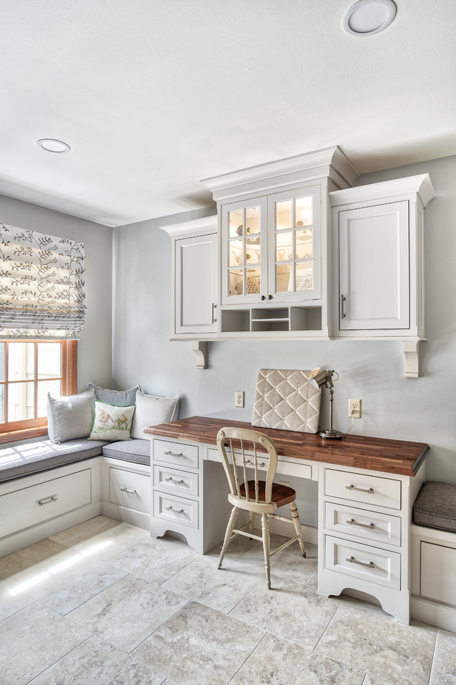 Example of a large transitional u-shaped eat-in kitchen design in New York with a farmhouse sink, beaded inset cabinets, white cabinets, white backsplash, subway tile backsplash, stainless steel appliances, a peninsula and black countertops