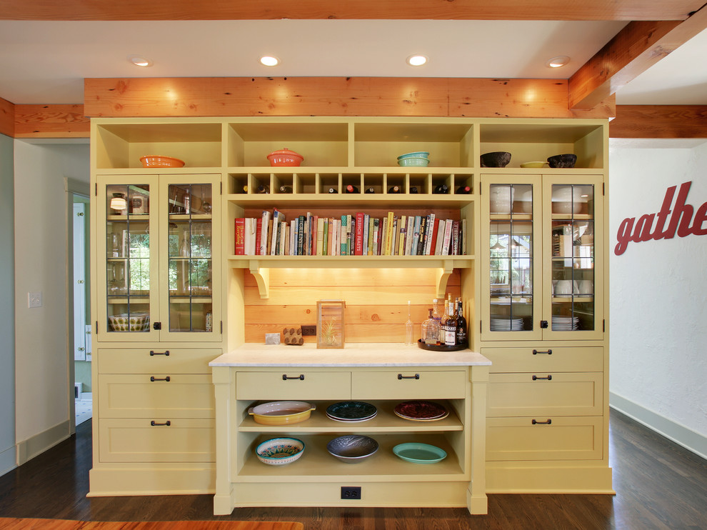 This is an example of a classic kitchen in Seattle with glass-front cabinets and yellow cabinets.