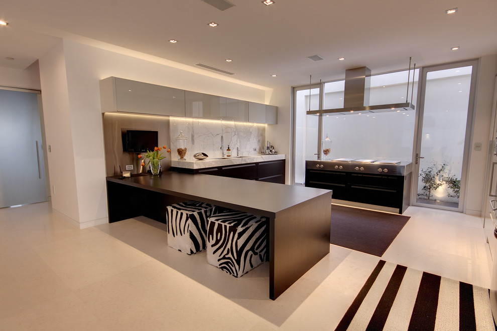 Eat-in kitchen - large modern u-shaped travertine floor eat-in kitchen idea in Brisbane with recessed-panel cabinets, dark wood cabinets, marble countertops, stone slab backsplash, paneled appliances and a peninsula