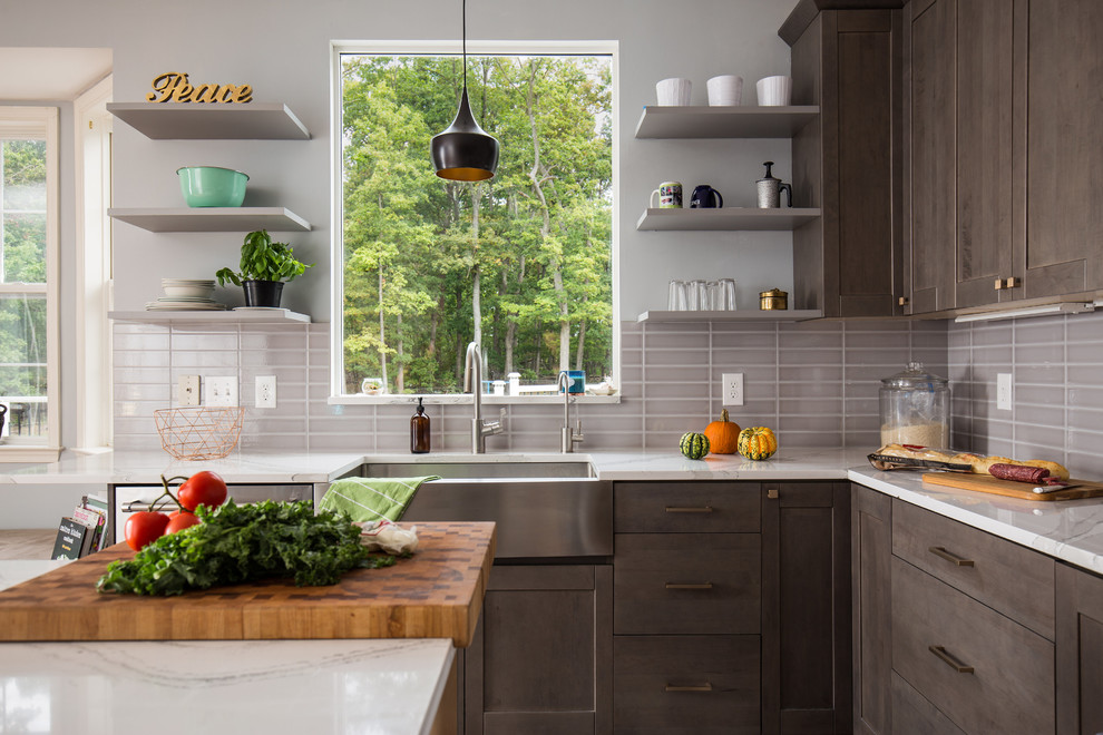 Inspiration for a large contemporary u-shaped kitchen/diner in DC Metro with a submerged sink, shaker cabinets, grey cabinets, engineered stone countertops, grey splashback, porcelain splashback, stainless steel appliances, medium hardwood flooring and an island.