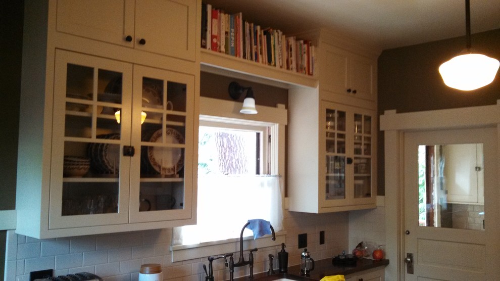 Mid-sized arts and crafts galley enclosed kitchen photo in Seattle with shaker cabinets, white cabinets, wood countertops, white backsplash, subway tile backsplash and no island