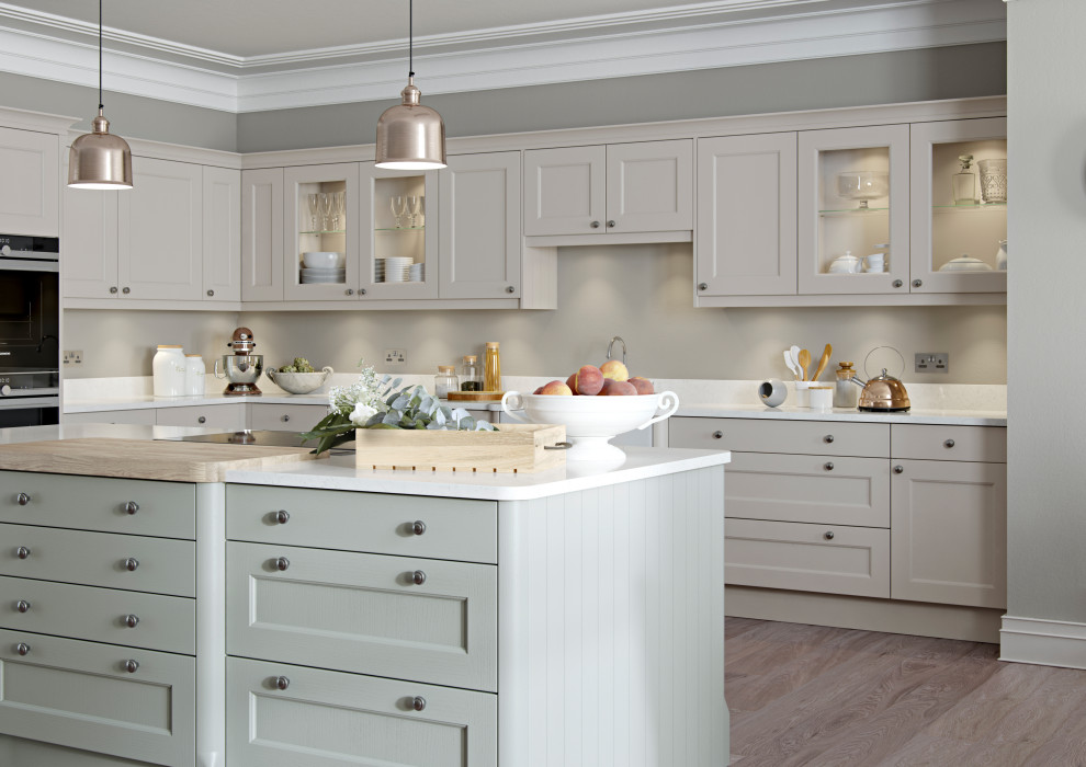 This is an example of a traditional kitchen/diner in Other with beaded cabinets, beige cabinets, grey splashback, an island and white worktops.