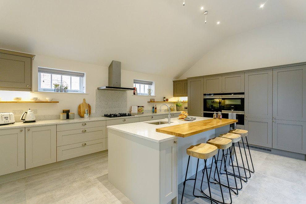 Design ideas for a country kitchen in Other with a submerged sink, shaker cabinets, grey cabinets, grey splashback, an island, grey floors and grey worktops.