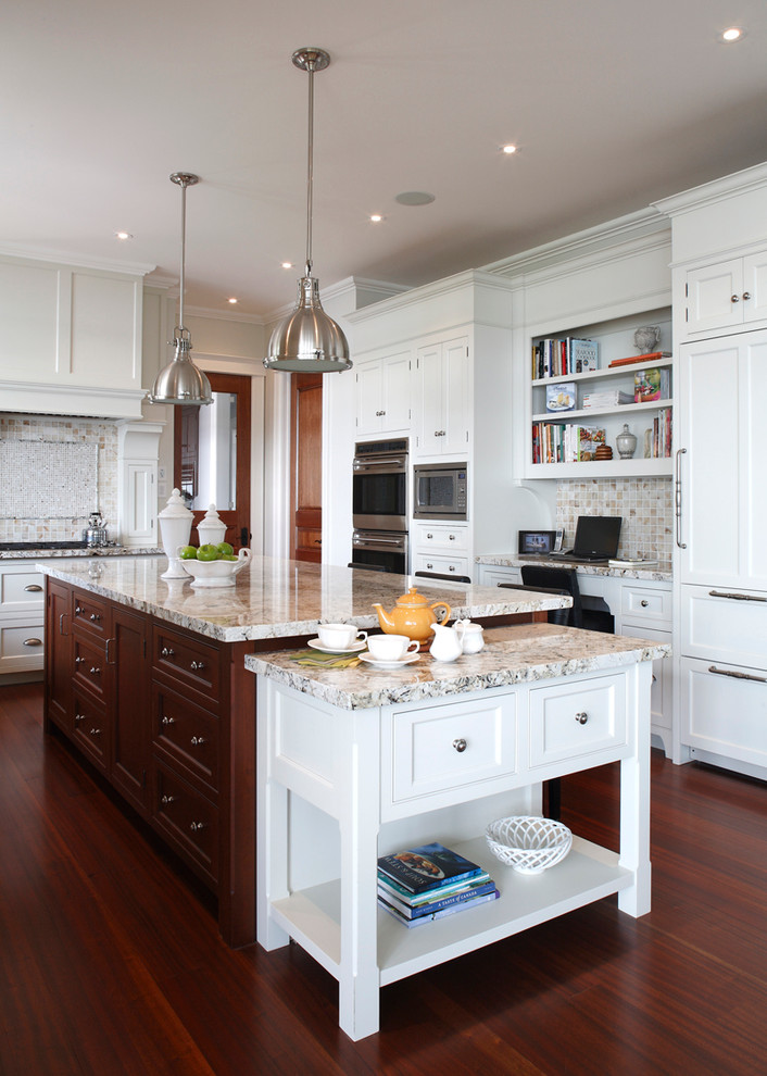 This is an example of a large traditional l-shaped open plan kitchen in Toronto with a submerged sink, white cabinets, granite worktops, dark hardwood flooring, an island, beaded cabinets, ceramic splashback, stainless steel appliances and multi-coloured splashback.