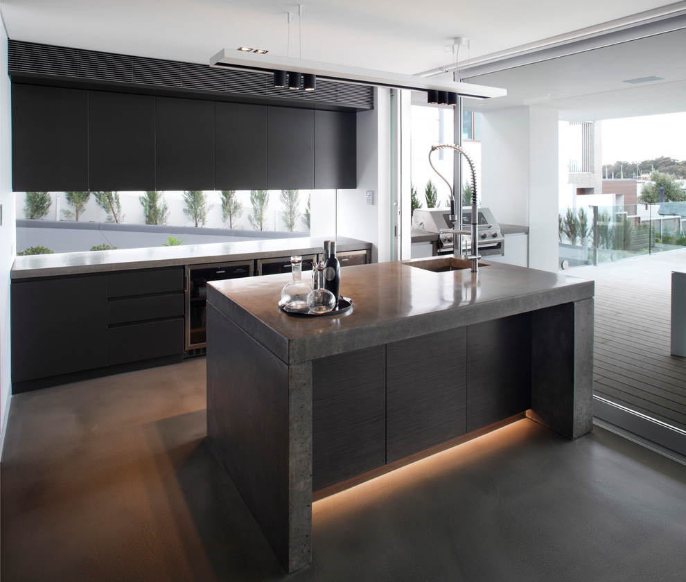 Photo of a medium sized contemporary galley kitchen in Sydney with flat-panel cabinets, black cabinets, stainless steel appliances and an island.