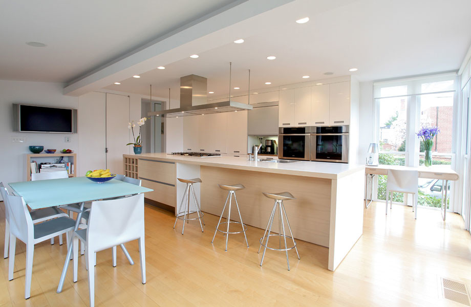 Eat-in kitchen - mid-sized modern single-wall light wood floor and yellow floor eat-in kitchen idea in Other with a drop-in sink, flat-panel cabinets, white cabinets, laminate countertops, paneled appliances, an island and white countertops