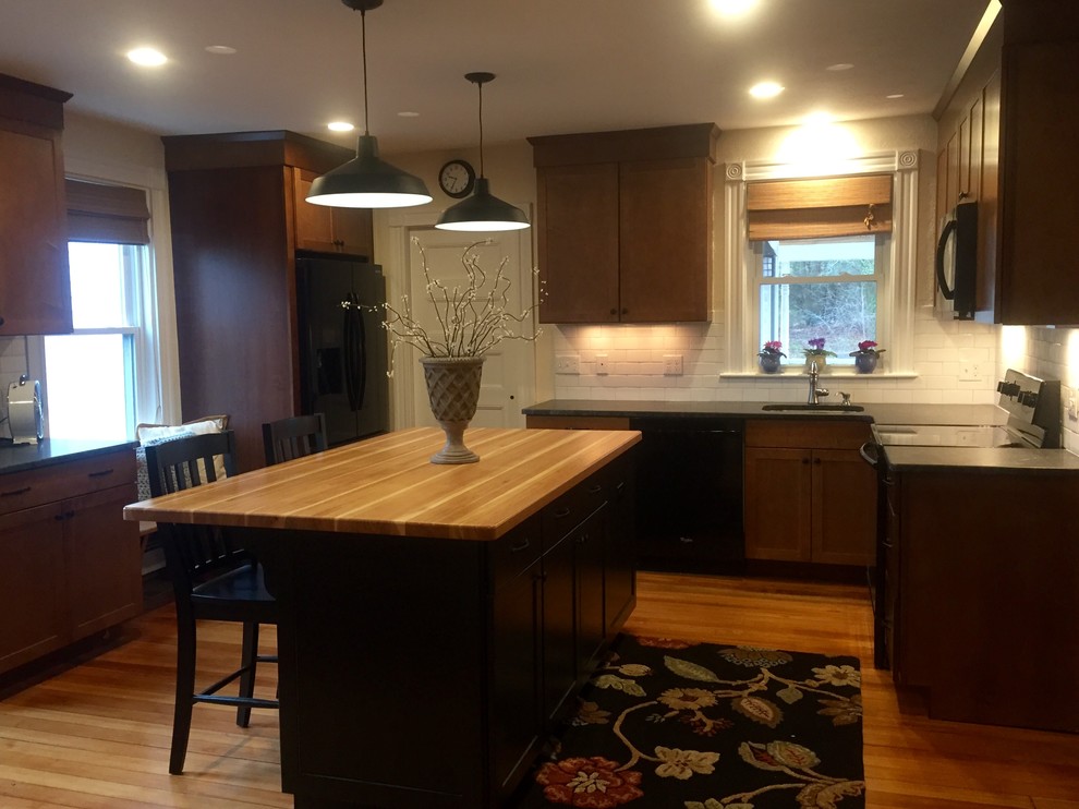 Classic kitchen in Providence with wood worktops and light hardwood flooring.