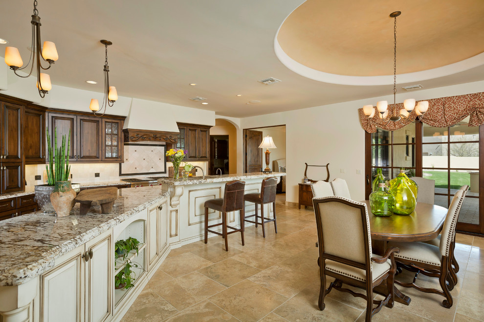 Inspiration for a large timeless galley travertine floor eat-in kitchen remodel in Phoenix with an undermount sink, medium tone wood cabinets, granite countertops, beige backsplash, stone tile backsplash, paneled appliances and an island