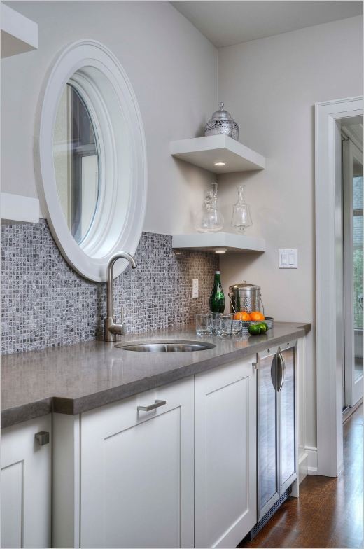 Eat-in kitchen - mid-sized transitional l-shaped light wood floor eat-in kitchen idea in Toronto with an undermount sink, shaker cabinets, white cabinets, granite countertops, metallic backsplash, mosaic tile backsplash, stainless steel appliances and an island