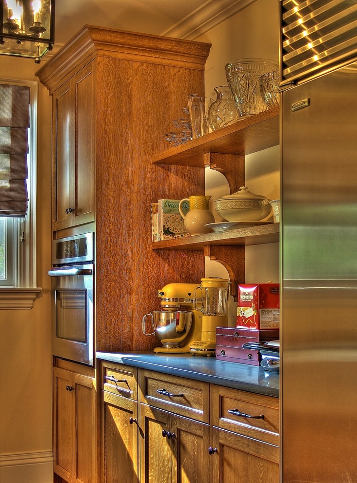 ニューヨークにあるエクレクティックスタイルのおしゃれなキッチン (中間色木目調キャビネット、シルバーの調理設備) の写真