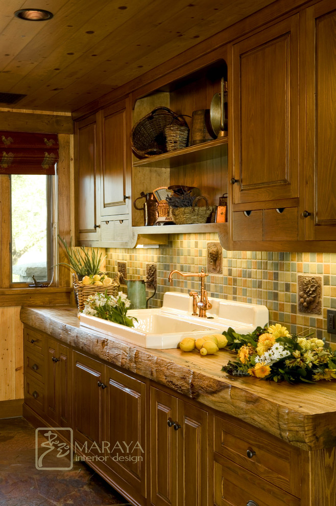 Large cottage single-wall slate floor enclosed kitchen photo in Santa Barbara with a drop-in sink, recessed-panel cabinets, wood countertops, green backsplash, ceramic backsplash, no island and paneled appliances