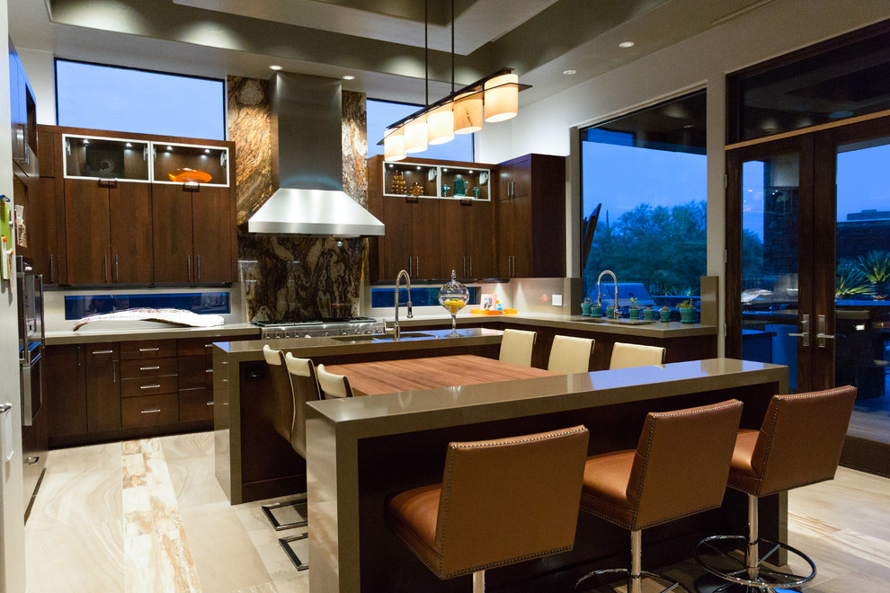 This is an example of a medium sized contemporary l-shaped kitchen/diner in Minneapolis with a double-bowl sink, flat-panel cabinets, dark wood cabinets, quartz worktops, stainless steel appliances, an island and beige floors.