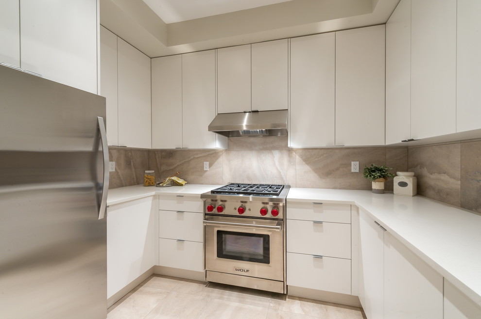 Example of a large trendy u-shaped light wood floor open concept kitchen design in Vancouver with an undermount sink, flat-panel cabinets, white cabinets, solid surface countertops, white backsplash, stone slab backsplash, stainless steel appliances and no island