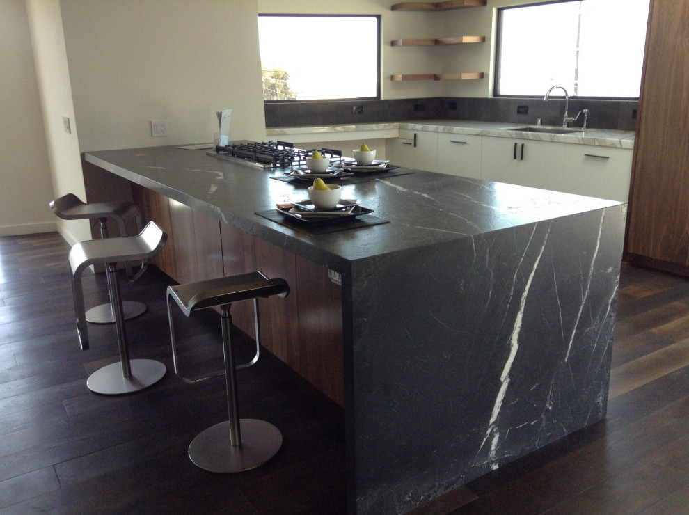 Cottage kitchen photo in London with marble countertops and black countertops