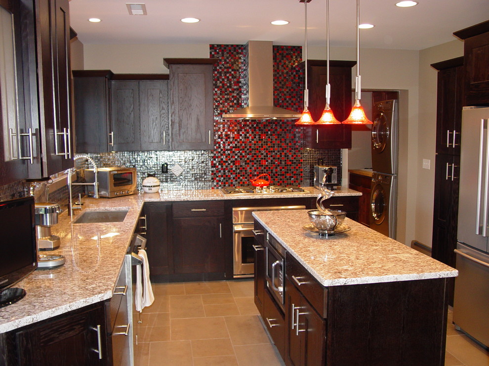Enclosed kitchen - large contemporary l-shaped travertine floor and beige floor enclosed kitchen idea in Cleveland with an undermount sink, shaker cabinets, dark wood cabinets, granite countertops, multicolored backsplash, mosaic tile backsplash, stainless steel appliances and an island