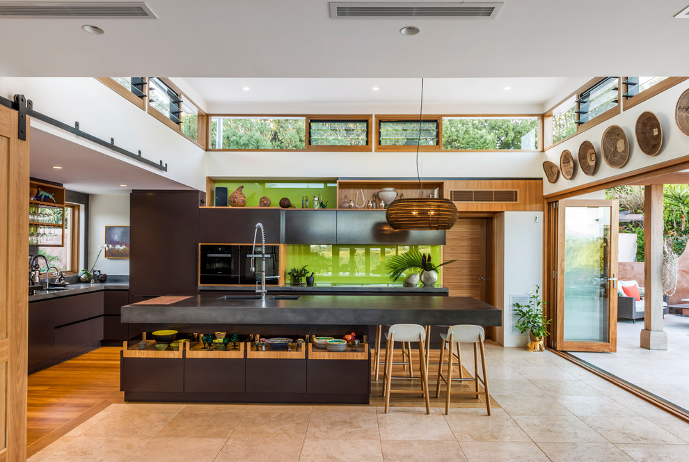 Eat-in kitchen - mid-sized contemporary l-shaped light wood floor and multicolored floor eat-in kitchen idea in Other with an undermount sink, dark wood cabinets, concrete countertops, green backsplash, glass sheet backsplash, stainless steel appliances, an island and flat-panel cabinets