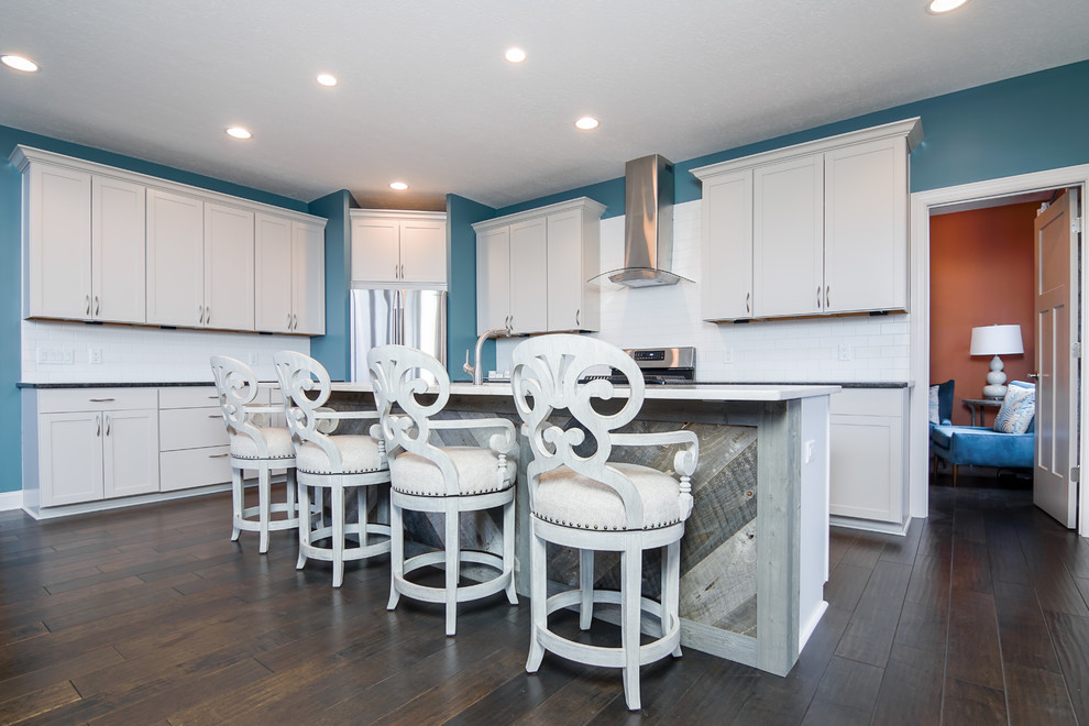 Example of a transitional l-shaped eat-in kitchen design in Cleveland with an island