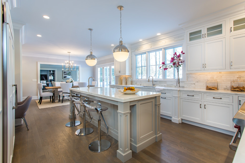Example of a transitional u-shaped medium tone wood floor eat-in kitchen design in Montreal with shaker cabinets, white cabinets and paneled appliances