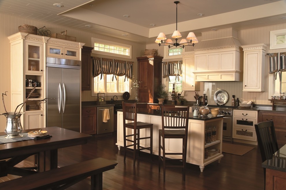 Classic kitchen in Other with stainless steel appliances and beige cabinets.