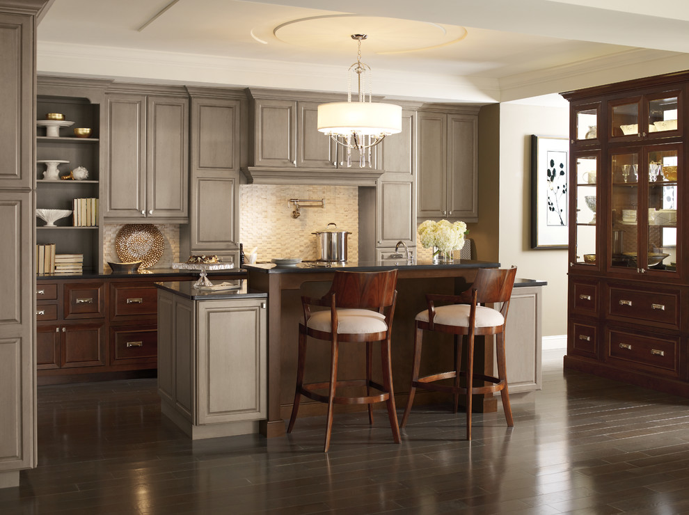Mid-sized elegant l-shaped enclosed kitchen photo in Baltimore with raised-panel cabinets, stainless steel appliances, an island and gray cabinets