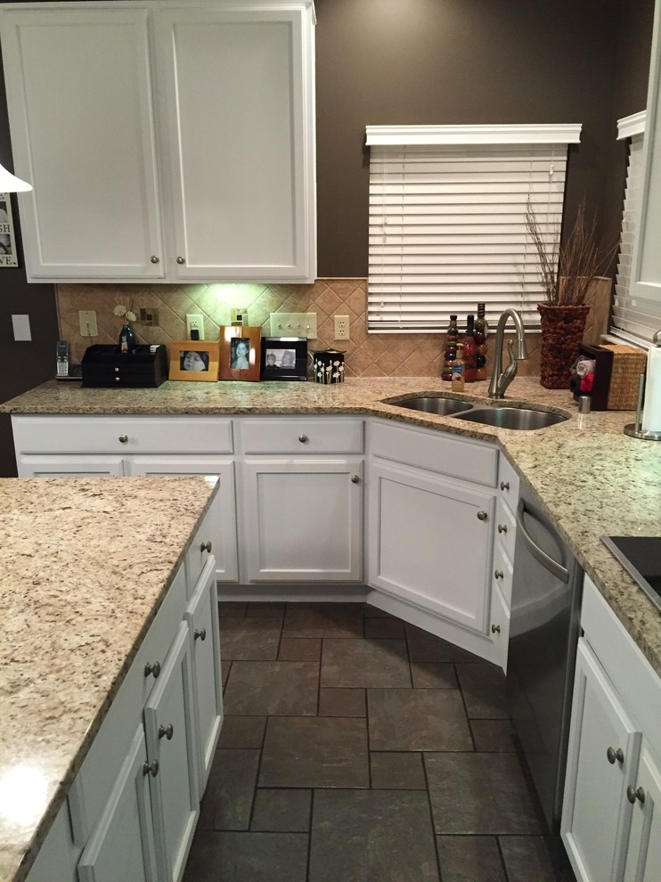 Inspiration for a timeless l-shaped gray floor kitchen remodel in Cincinnati with a double-bowl sink, recessed-panel cabinets, white cabinets, granite countertops, beige backsplash, stone tile backsplash, stainless steel appliances and an island