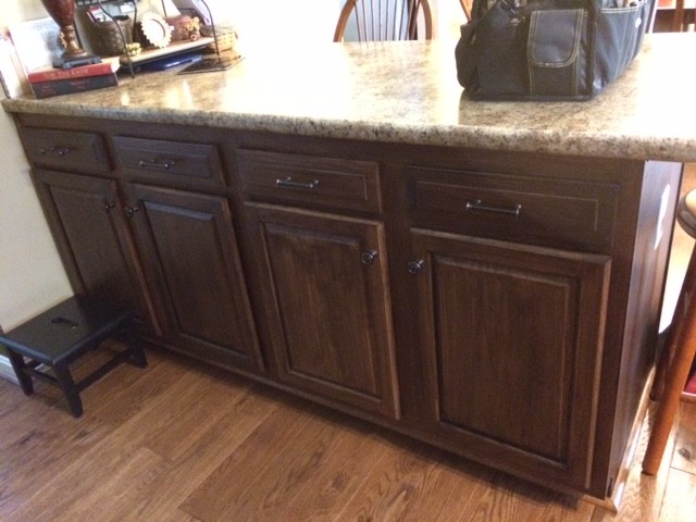 Enclosed kitchen - mid-sized traditional l-shaped dark wood floor and brown floor enclosed kitchen idea in Cincinnati with a double-bowl sink, raised-panel cabinets, dark wood cabinets, granite countertops, multicolored backsplash, matchstick tile backsplash, stainless steel appliances and an island