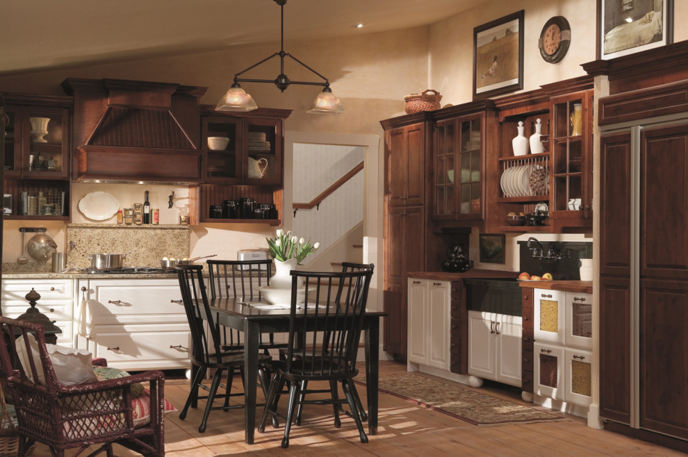 Eat-in kitchen - mid-sized farmhouse l-shaped bamboo floor and beige floor eat-in kitchen idea in Baltimore with raised-panel cabinets, dark wood cabinets, granite countertops, a farmhouse sink, beige backsplash, ceramic backsplash, paneled appliances and no island