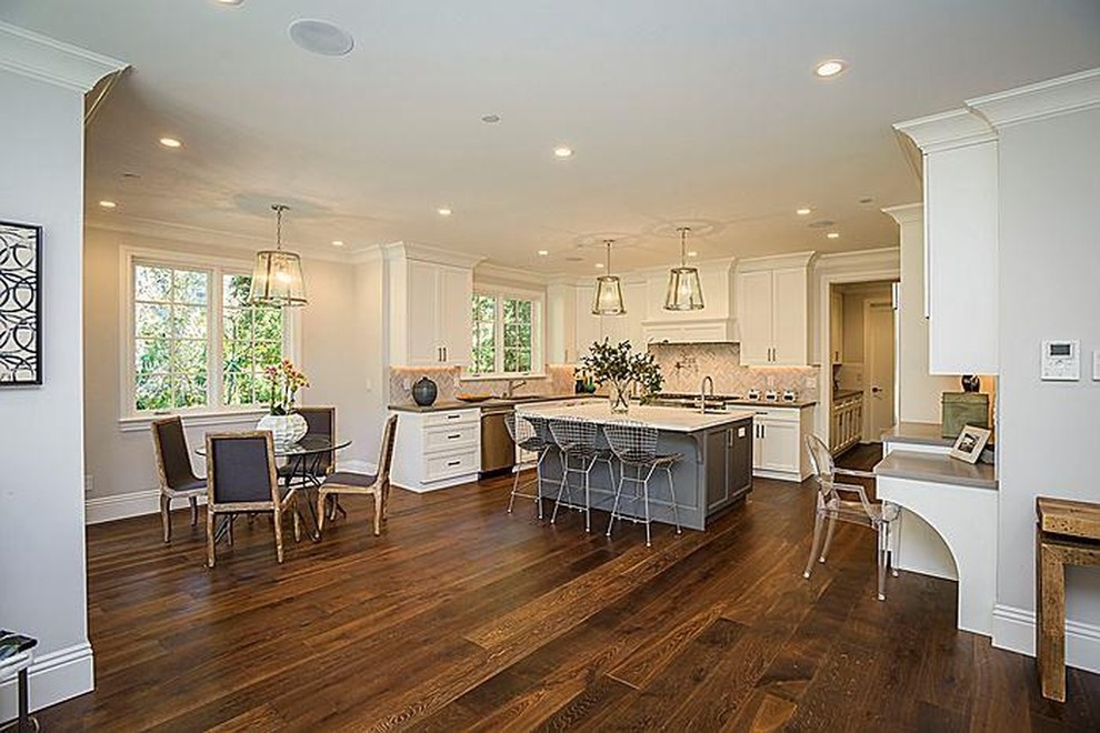 Inspiration for a large transitional u-shaped dark wood floor eat-in kitchen remodel in San Francisco with an undermount sink, recessed-panel cabinets, white cabinets, quartzite countertops, gray backsplash, stone tile backsplash, stainless steel appliances and an island
