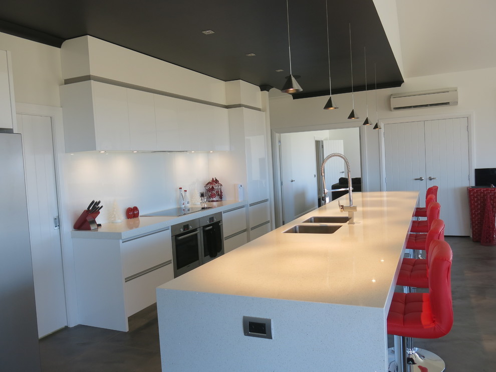 This is an example of a contemporary kitchen in Hamilton with engineered stone countertops.