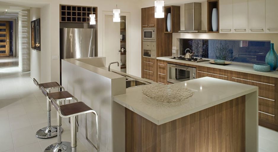 Example of a huge minimalist l-shaped porcelain tile and white floor enclosed kitchen design in San Francisco with a double-bowl sink, flat-panel cabinets, medium tone wood cabinets, limestone countertops, stainless steel appliances, an island and white countertops