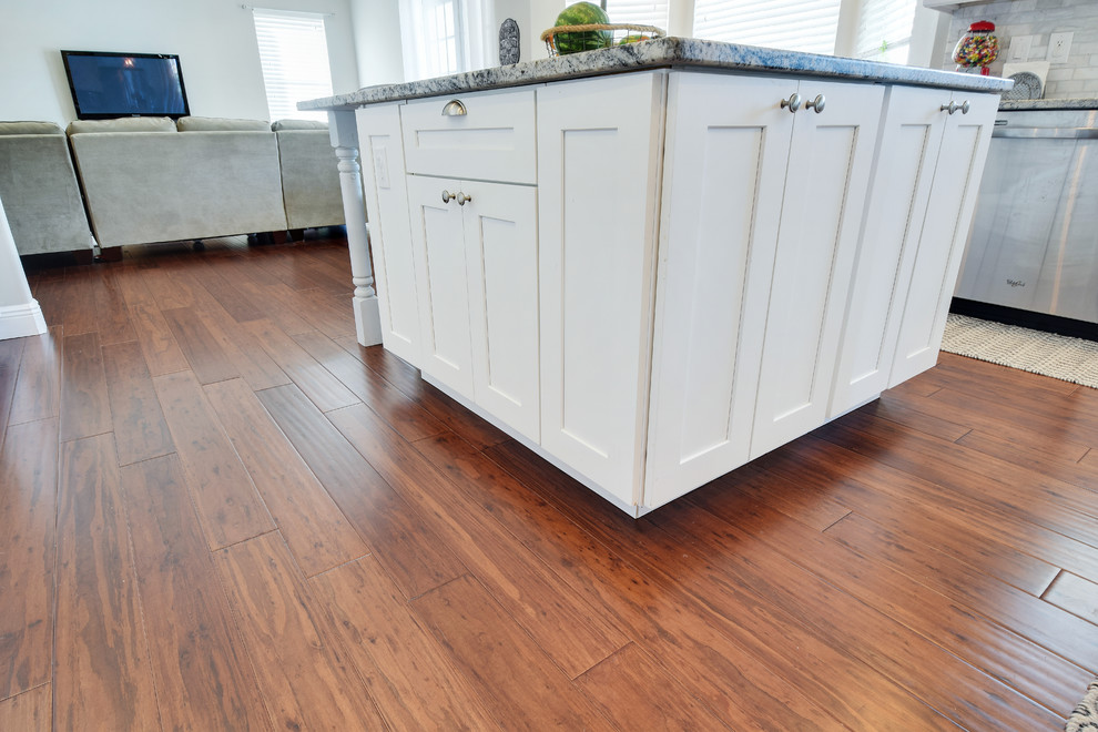 Photo of a classic kitchen in Baltimore with bamboo flooring and brown floors.