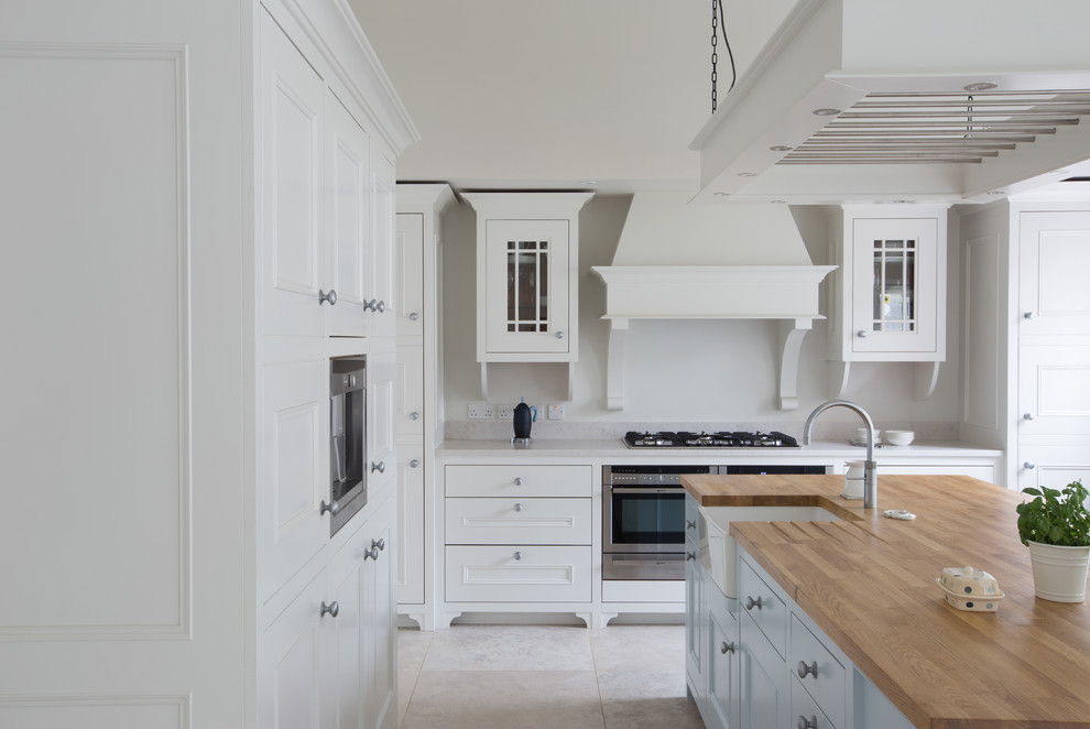 Design ideas for a large traditional l-shaped open plan kitchen in Dublin with a belfast sink, beaded cabinets, quartz worktops, stainless steel appliances and an island.