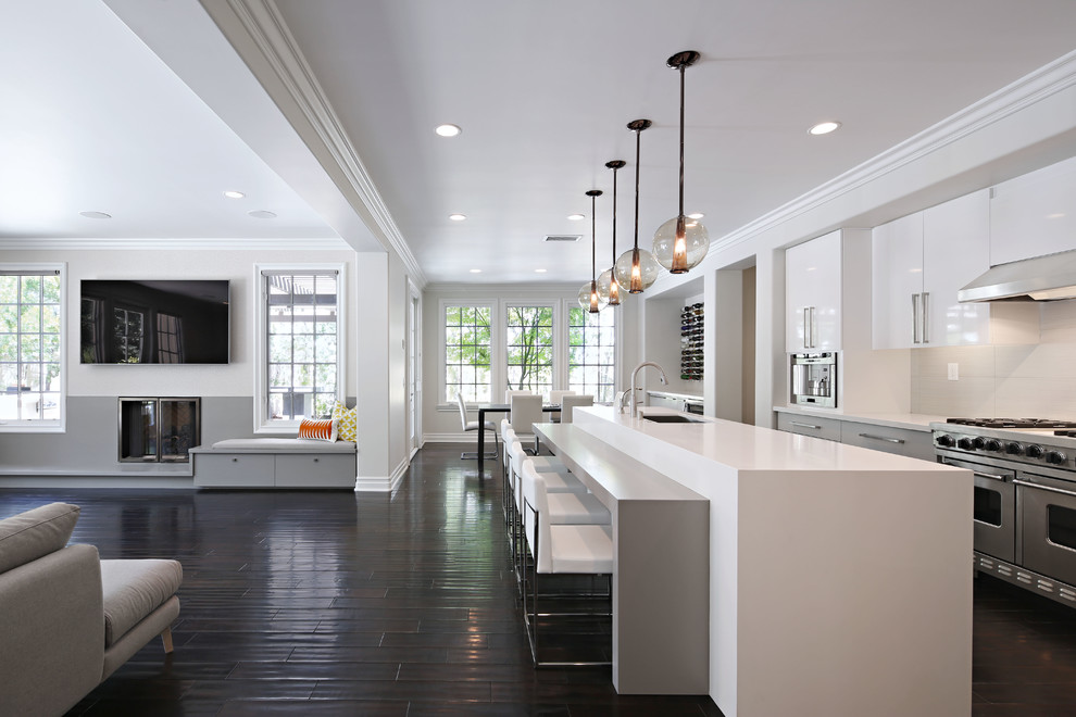 Inspiration for a large contemporary galley dark wood floor open concept kitchen remodel in Los Angeles with flat-panel cabinets, white cabinets, white backsplash, stainless steel appliances, an undermount sink, quartz countertops, porcelain backsplash and an island