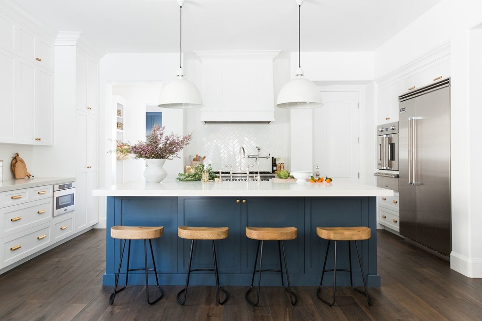Inspiration for a large transitional u-shaped dark wood floor and brown floor kitchen remodel in Salt Lake City with shaker cabinets, blue cabinets, white backsplash, stainless steel appliances, an island and white countertops