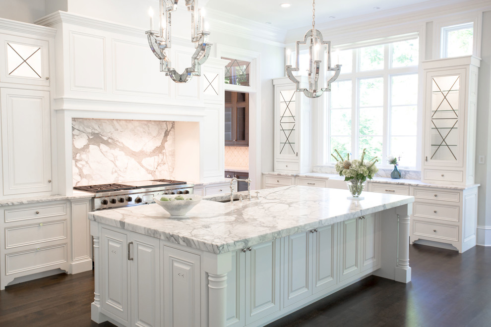 Example of a transitional u-shaped dark wood floor kitchen design in Richmond with a farmhouse sink, recessed-panel cabinets, white cabinets, marble countertops, white backsplash, stone slab backsplash, stainless steel appliances and an island
