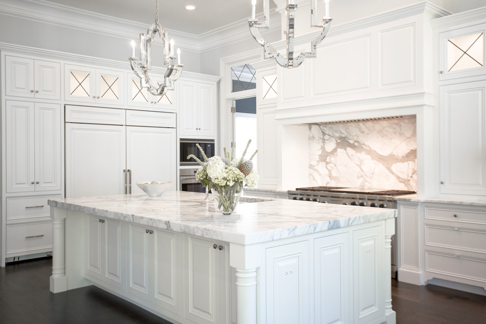 Kitchen - transitional u-shaped dark wood floor kitchen idea in Richmond with a farmhouse sink, recessed-panel cabinets, white cabinets, marble countertops, white backsplash, stone slab backsplash, stainless steel appliances and an island