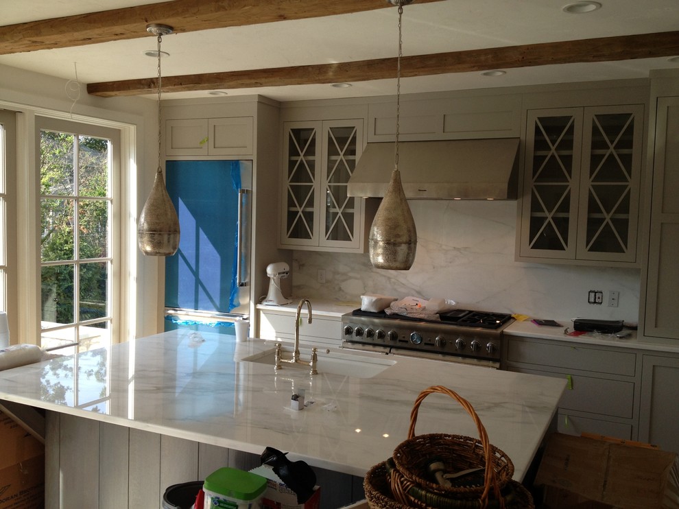 Photo of a modern kitchen/diner in New York with a built-in sink and marble worktops.