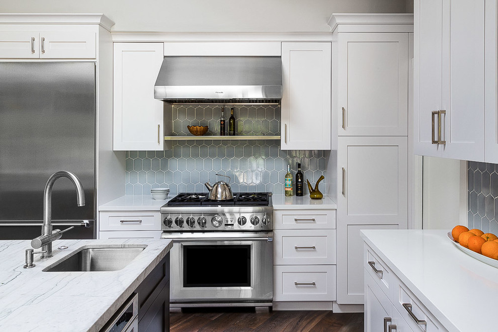 Design ideas for a classic kitchen in San Francisco with a submerged sink, shaker cabinets, white cabinets, blue splashback, porcelain splashback, stainless steel appliances, dark hardwood flooring, an island and brown floors.