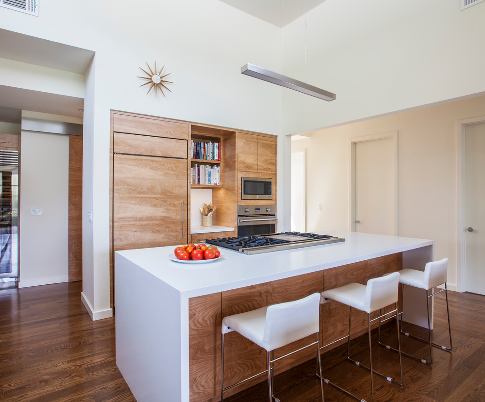 Photo of a contemporary kitchen in San Francisco with flat-panel cabinets, light wood cabinets and an island.