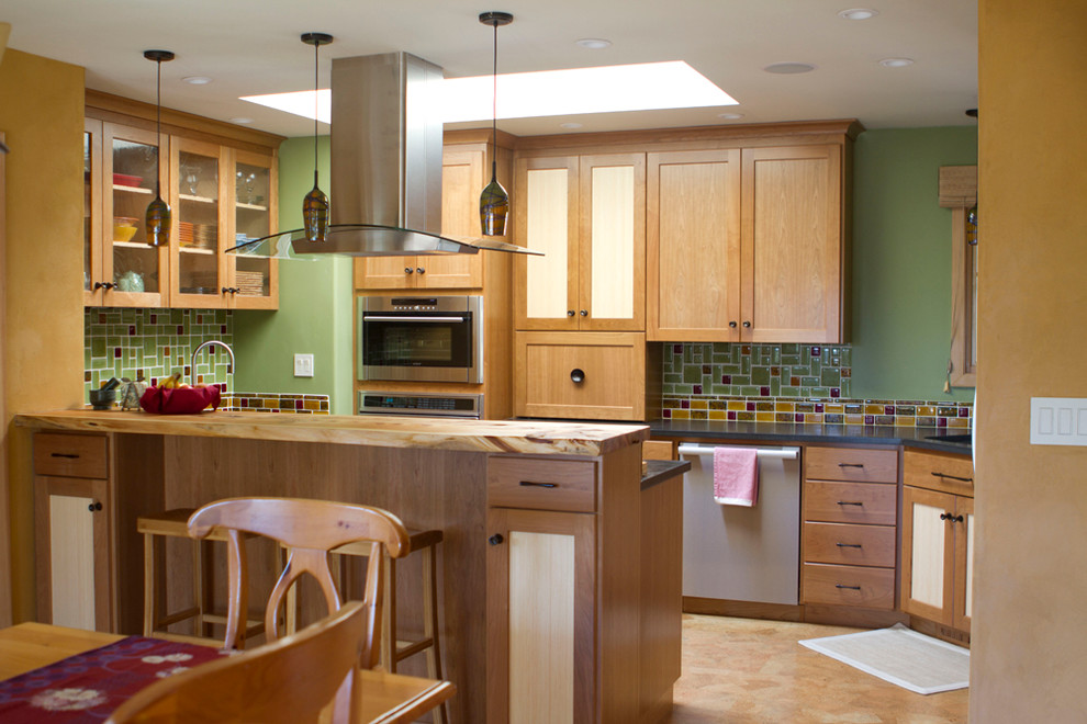 Arts and crafts cork floor kitchen photo in San Francisco with concrete countertops, green backsplash and stainless steel appliances