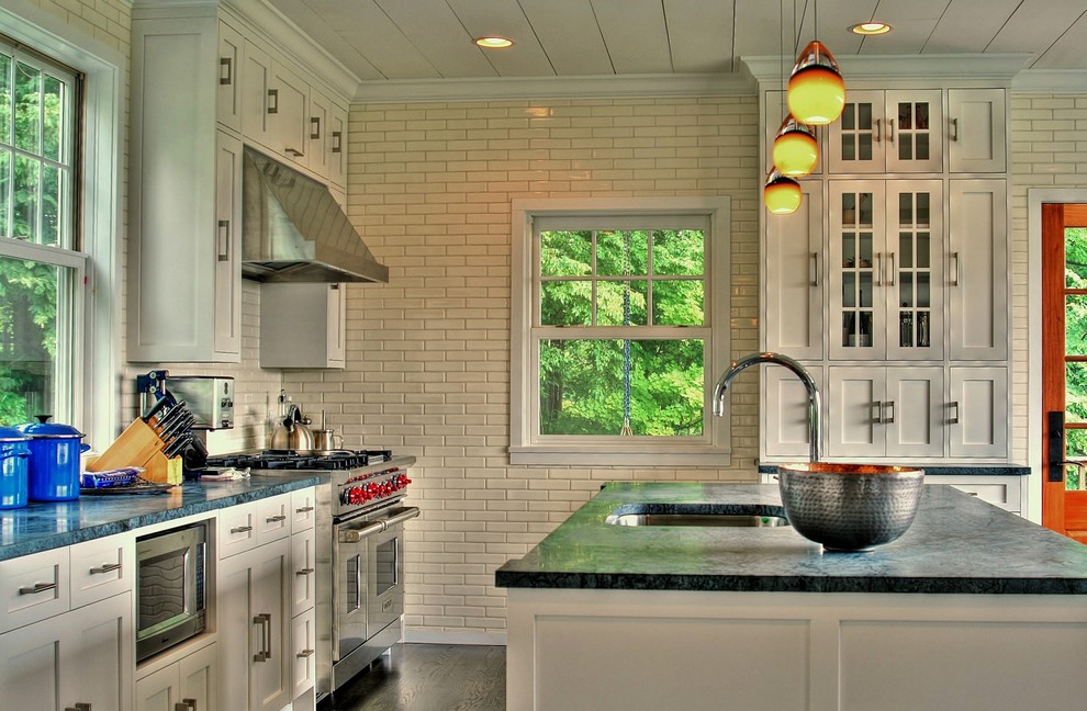Example of a classic kitchen design in New York with stainless steel appliances and soapstone countertops