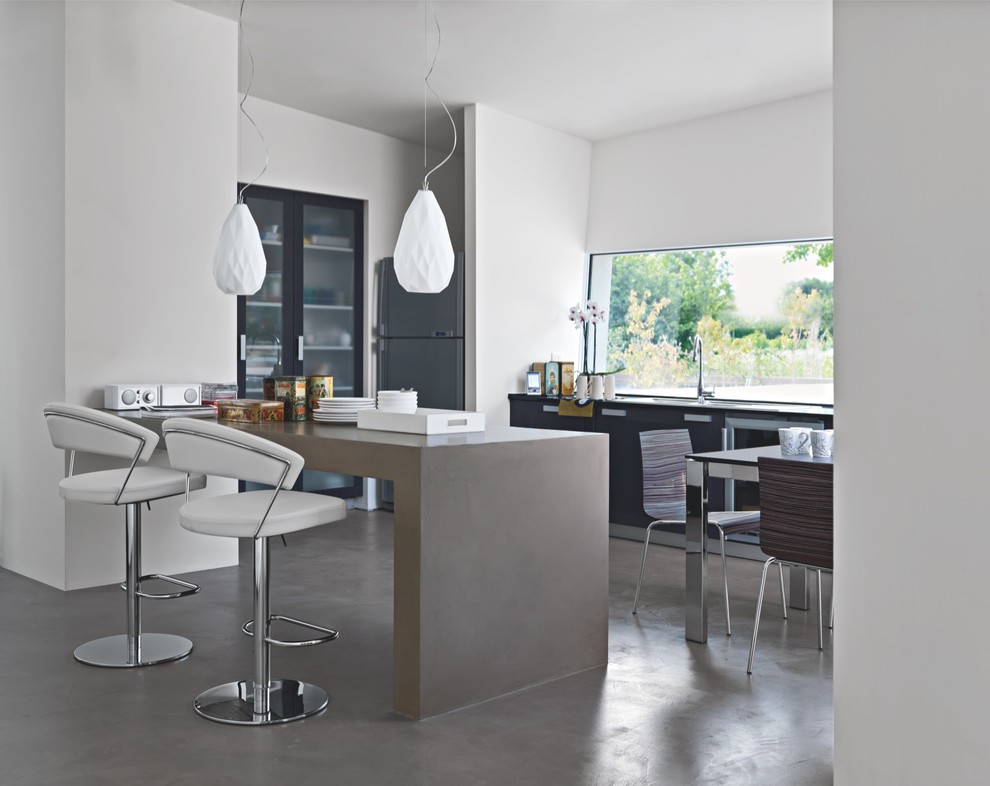 Example of a mid-sized trendy concrete floor open concept kitchen design in San Diego with glass-front cabinets, black cabinets, concrete countertops, stainless steel appliances and an island
