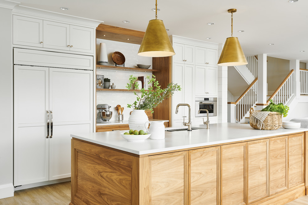 Design ideas for a large coastal l-shaped kitchen/diner in Vancouver with a double-bowl sink, shaker cabinets, white cabinets, quartz worktops, white splashback, ceramic splashback, stainless steel appliances, vinyl flooring, an island, beige floors and white worktops.