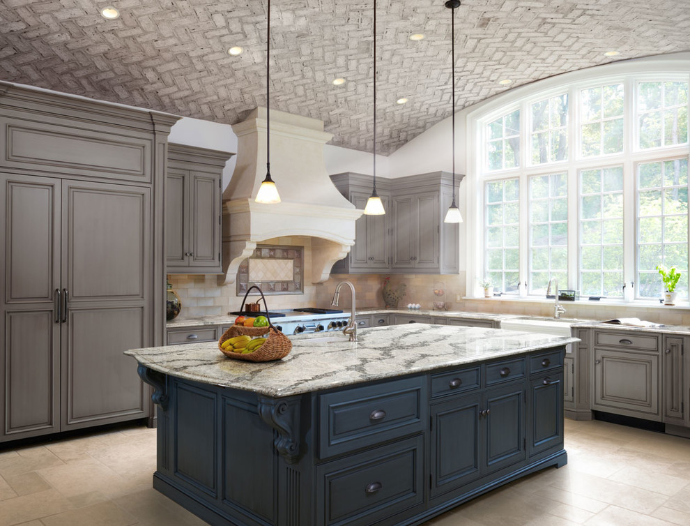 Inspiration for a large classic l-shaped open plan kitchen in New Orleans with a belfast sink, recessed-panel cabinets, grey cabinets, granite worktops, beige splashback, ceramic splashback, integrated appliances, ceramic flooring and an island.
