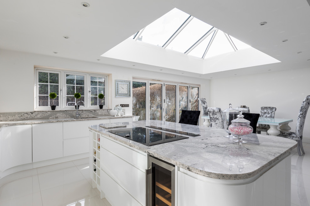 Large contemporary kitchen in Other with white cabinets, marble worktops, white splashback and stone slab splashback.