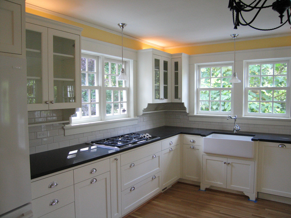 Ejemplo de cocinas en L clásica con fregadero sobremueble, salpicadero blanco, salpicadero de azulejos tipo metro y encimera de granito