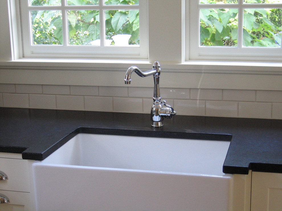 Inspiration for a timeless l-shaped kitchen remodel in Portland with a farmhouse sink, granite countertops, white backsplash and subway tile backsplash