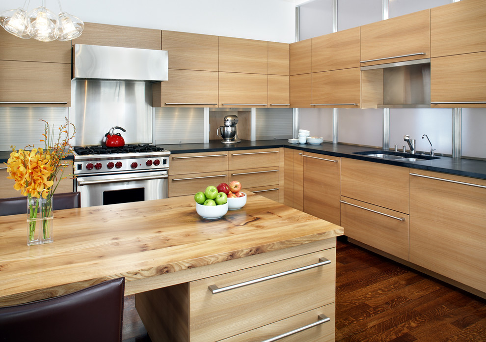 Inspiration for a contemporary kitchen remodel in Boston with wood countertops, stainless steel appliances, a double-bowl sink, flat-panel cabinets, light wood cabinets, metal backsplash and metallic backsplash